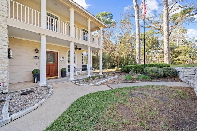 view of yard featuring a balcony and a porch