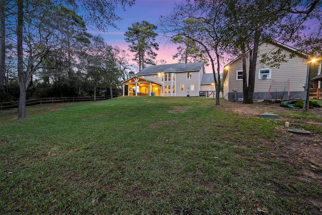 view of yard at dusk