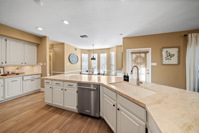 kitchen featuring dishwasher, white cabinetry, sink, and pendant lighting