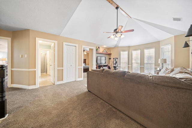 carpeted living room featuring lofted ceiling and ceiling fan