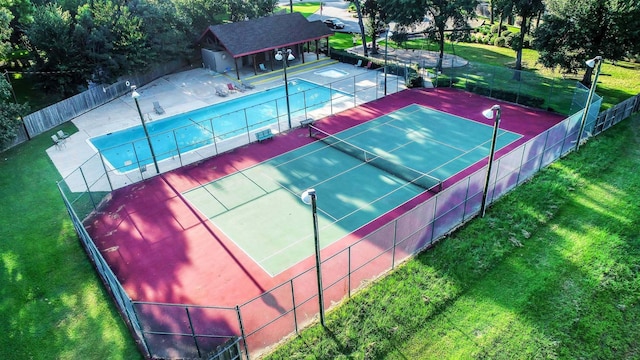 view of sport court featuring a yard