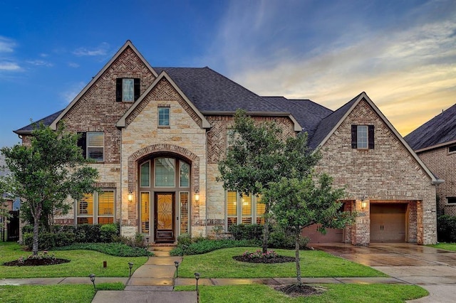 view of front of home with a lawn and a garage