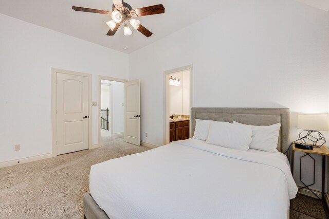 carpeted bedroom featuring ensuite bath and ceiling fan