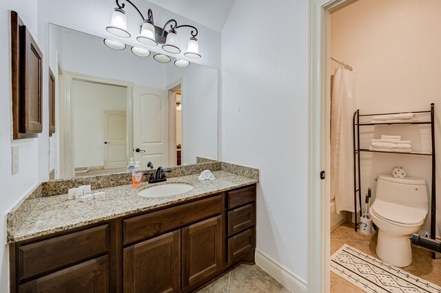 bathroom featuring tile patterned floors, vanity, toilet, and walk in shower