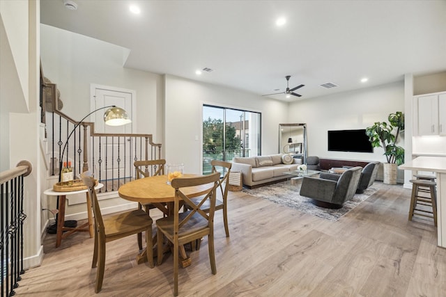 dining room with ceiling fan and light hardwood / wood-style flooring