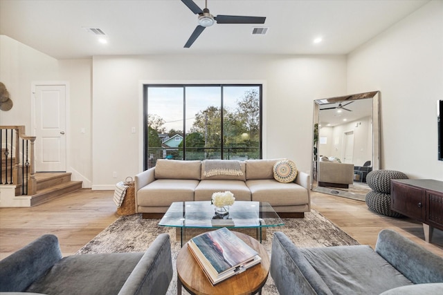 living room featuring light hardwood / wood-style flooring and ceiling fan