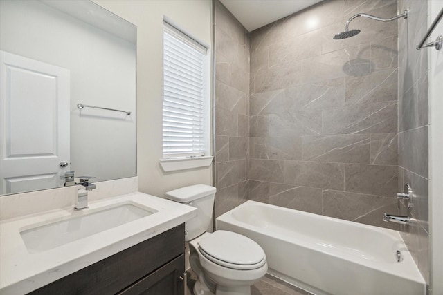 full bathroom with vanity, toilet, plenty of natural light, and tiled shower / bath