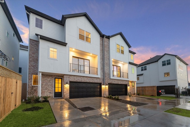 contemporary home featuring a balcony and a garage