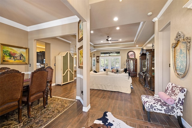 interior space featuring dark hardwood / wood-style floors, ceiling fan, crown molding, and a tray ceiling