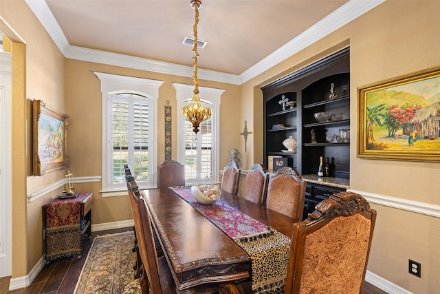 dining area featuring a chandelier, built in shelves, crown molding, and dark wood-type flooring