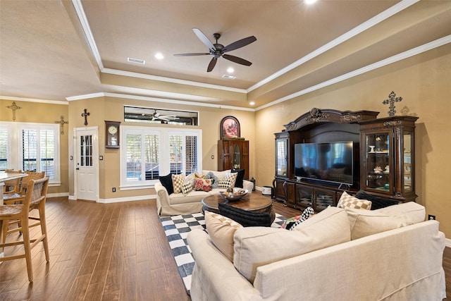 living room featuring hardwood / wood-style floors, a tray ceiling, ceiling fan, and crown molding