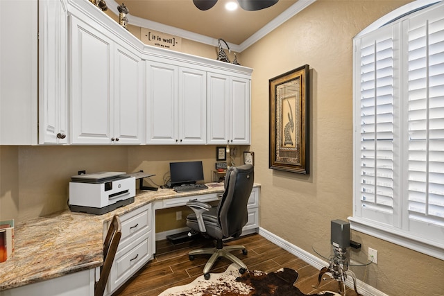 home office with crown molding and built in desk