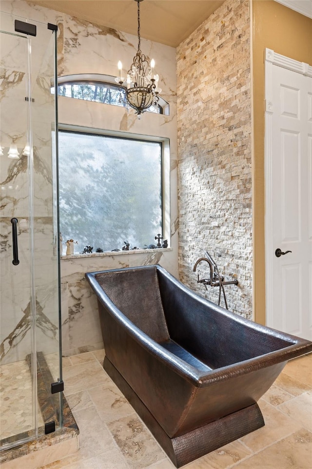 bathroom featuring shower with separate bathtub and an inviting chandelier