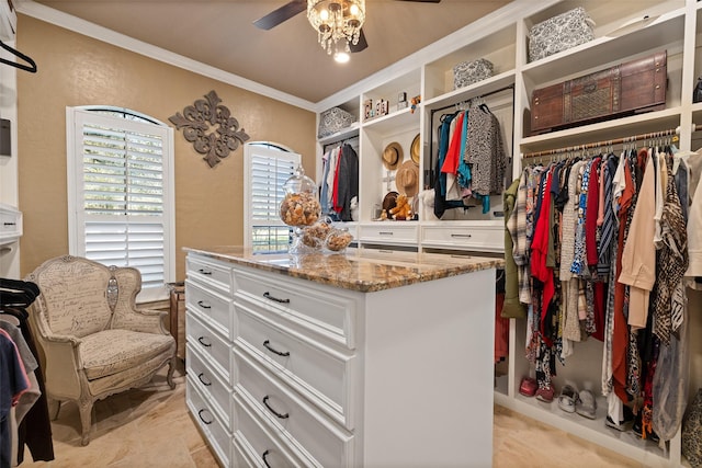 walk in closet with ceiling fan