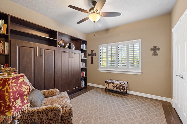 sitting room featuring hardwood / wood-style floors and ceiling fan