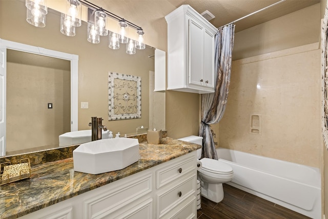 full bathroom featuring toilet, vanity, and shower / tub combo with curtain