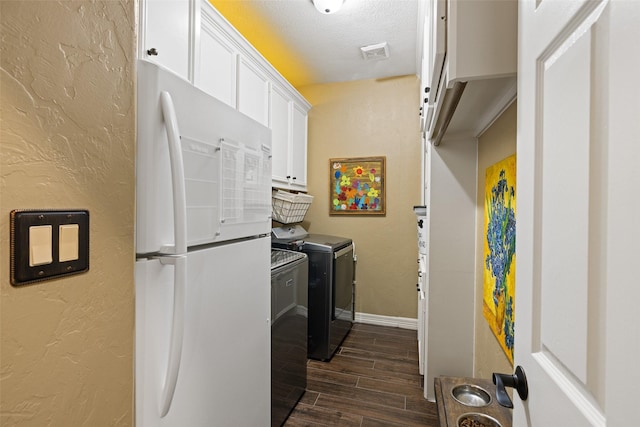 washroom featuring washer and dryer and a textured ceiling