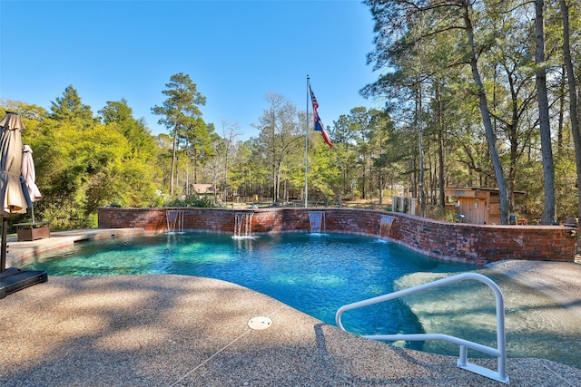 view of pool featuring pool water feature and a patio area