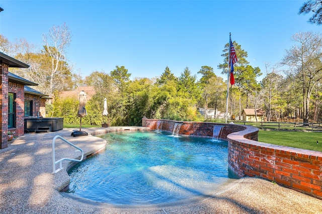 view of pool with pool water feature and a hot tub