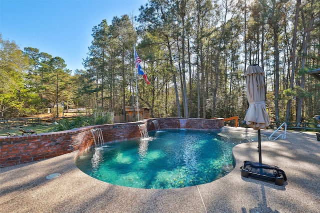 view of swimming pool featuring pool water feature and a patio area