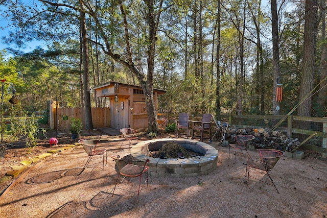 view of patio / terrace featuring a storage shed and an outdoor fire pit