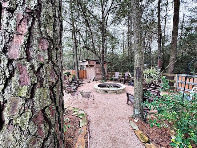 view of patio / terrace featuring a storage unit and an outdoor fire pit