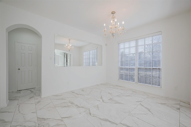 empty room featuring a chandelier