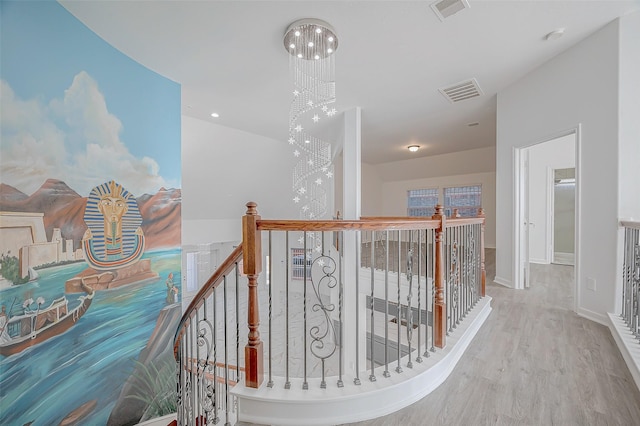 hallway featuring a chandelier and wood-type flooring