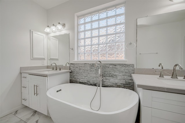 bathroom with a healthy amount of sunlight, vanity, and a tub