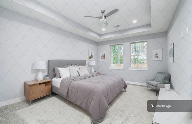 bedroom featuring ceiling fan and a raised ceiling