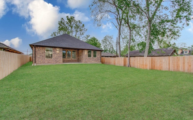 back of house with a lawn