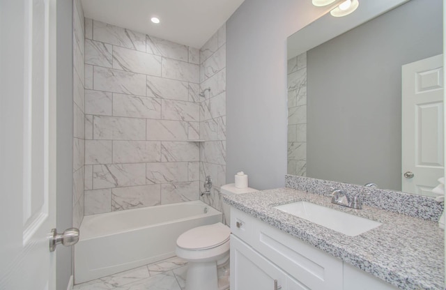 full bathroom featuring vanity, tiled shower / bath combo, and toilet