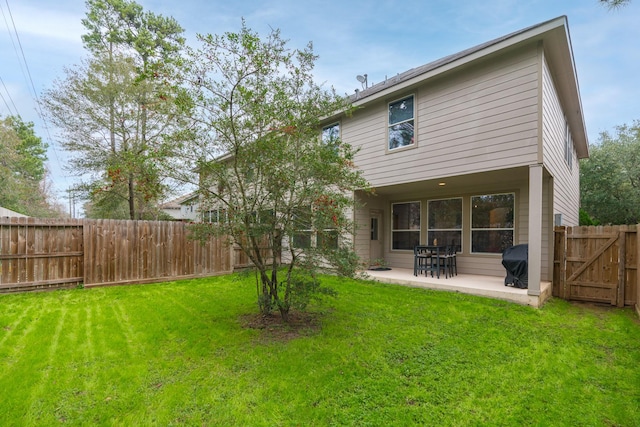 back of property featuring a yard and a patio