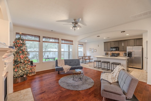 living room featuring hardwood / wood-style floors and ceiling fan