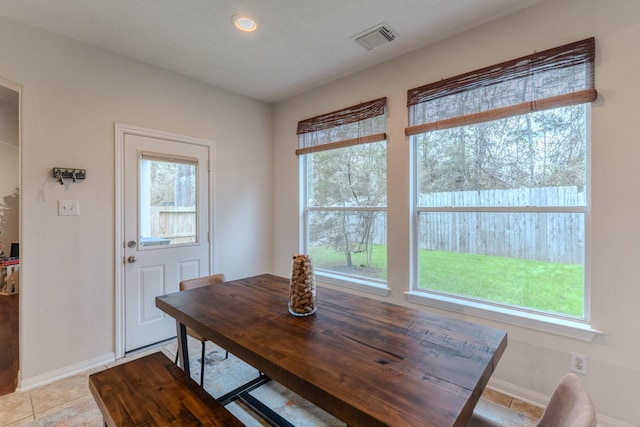 dining area featuring plenty of natural light and light tile patterned flooring