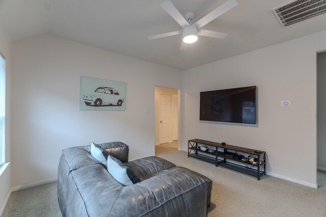 carpeted living room featuring ceiling fan and vaulted ceiling