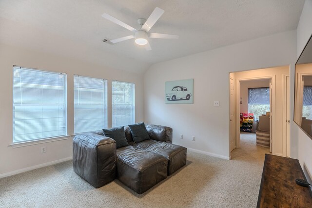 carpeted living room featuring ceiling fan and lofted ceiling