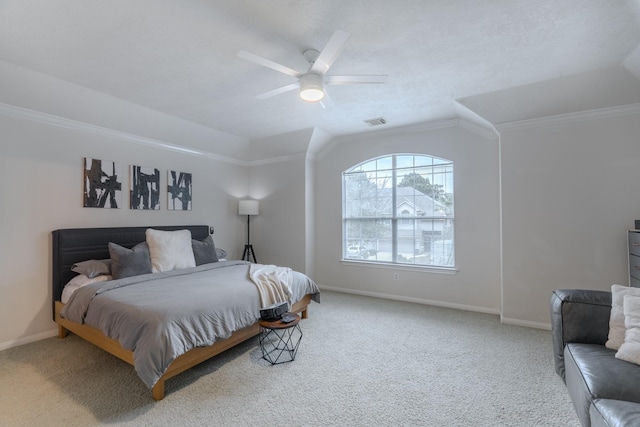 bedroom featuring a raised ceiling, ceiling fan, carpet, and ornamental molding