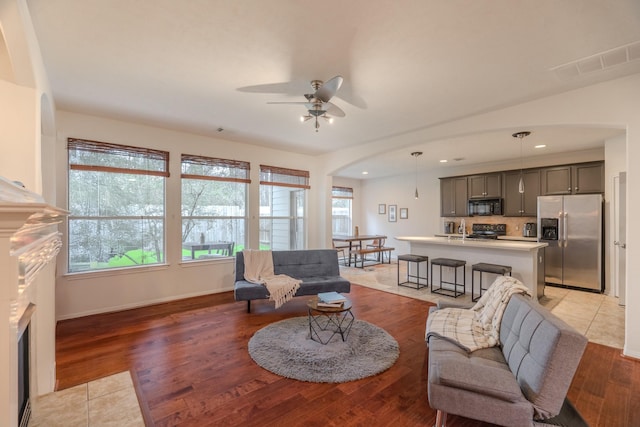 living area featuring recessed lighting, visible vents, a wealth of natural light, and wood finished floors