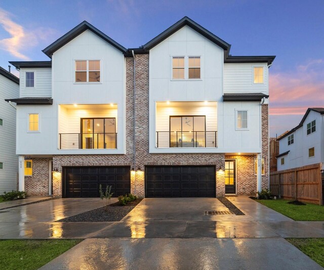 view of front of home with a balcony and a garage