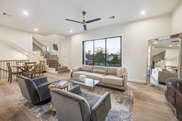 living room featuring ceiling fan and light hardwood / wood-style floors