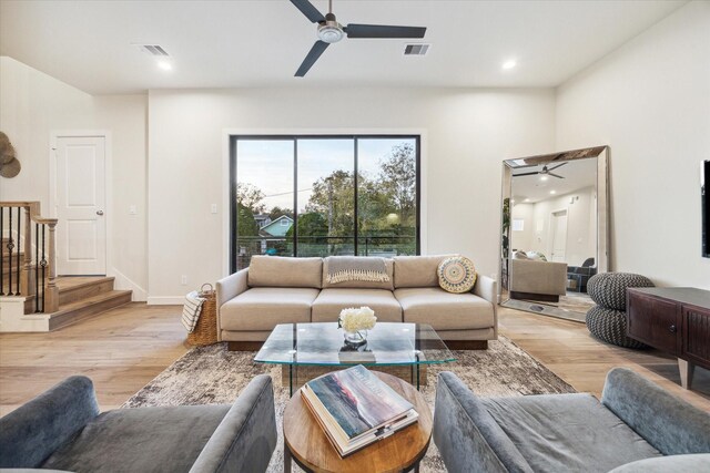 living room featuring ceiling fan and light wood-type flooring