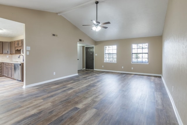 unfurnished living room featuring beam ceiling, ceiling fan, sink, and hardwood / wood-style flooring