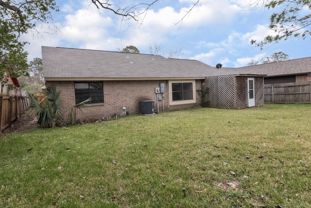 rear view of property with a lawn