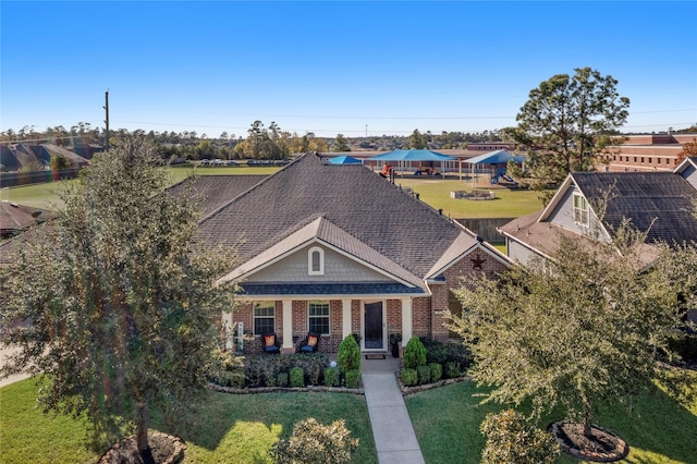 craftsman house featuring covered porch and a front yard