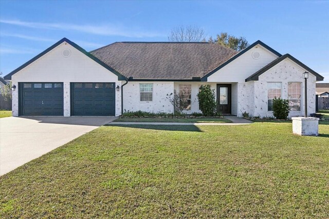 view of front of house with a front yard and a garage