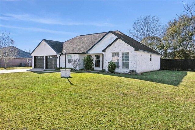 view of front of house with a front yard and a garage