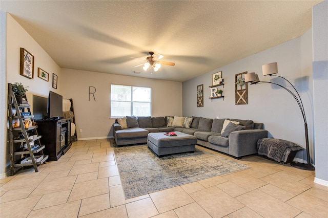 living room featuring a textured ceiling, ceiling fan, and light tile patterned flooring