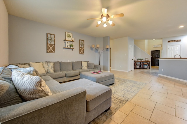 living room with light tile patterned floors and ceiling fan