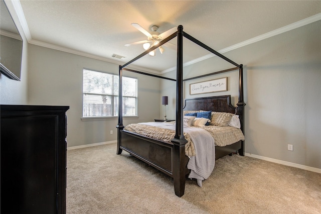 carpeted bedroom featuring ceiling fan and crown molding